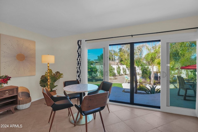 dining room with baseboards and tile patterned floors