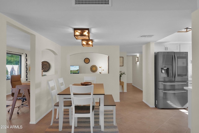 dining space featuring visible vents, baseboards, and light tile patterned floors