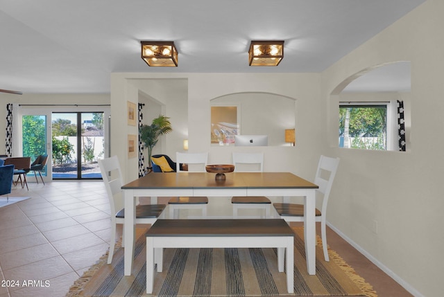 tiled dining room with baseboards