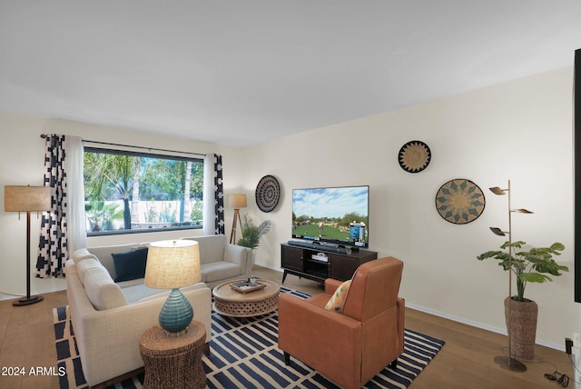 living area with wood finished floors and baseboards