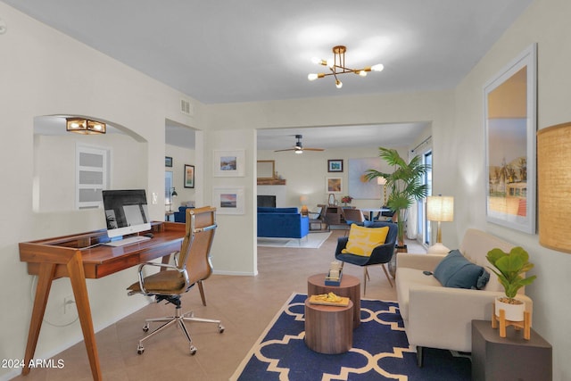 office space with ceiling fan with notable chandelier, a fireplace, visible vents, baseboards, and tile patterned floors