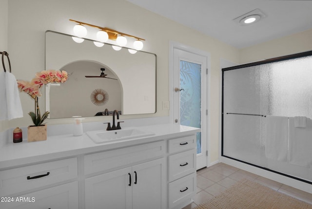 full bath featuring a stall shower, vanity, a ceiling fan, and tile patterned floors