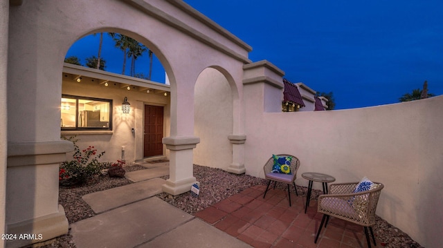 exterior space with a patio, fence, and stucco siding