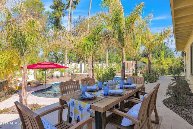 view of patio with outdoor dining area and fence