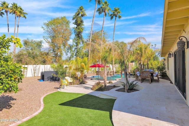 view of yard with a patio area, a fenced backyard, and a fenced in pool