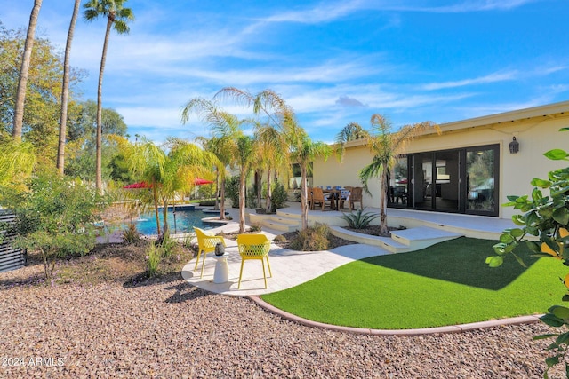 view of yard featuring a patio area and an outdoor pool