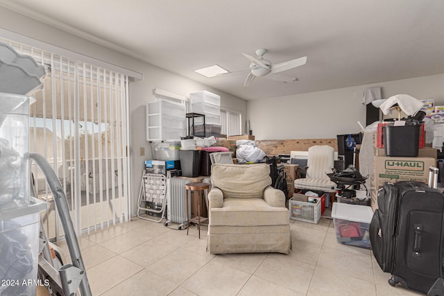 interior space with ceiling fan and light tile patterned flooring