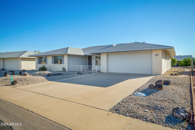 single story home with covered porch and a garage