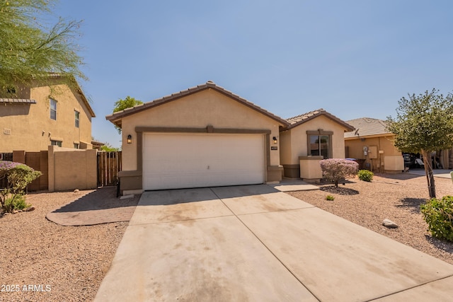 41767 W Somerset Dr, Maricopa, AZ 85138 - view of front of home with driveway, stucco siding, an attached garage, a tile roof, and a gate