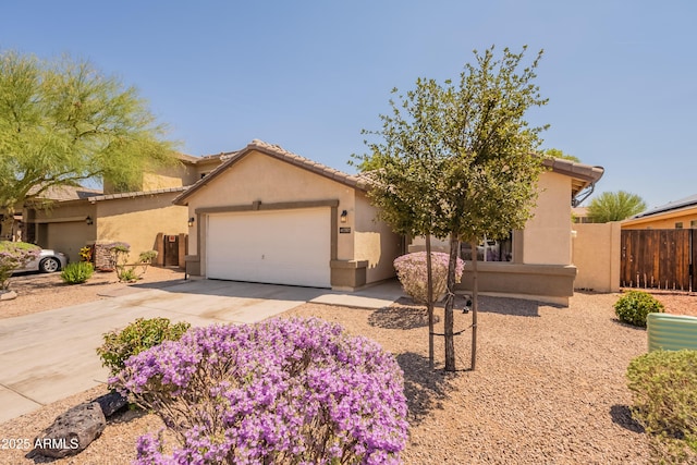 41767 W Somerset Dr, Maricopa, AZ 85138 - view of front of house featuring an attached garage, concrete driveway, stucco siding, and a tiled roof