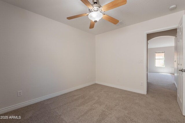 41767 W Somerset Dr, Maricopa, AZ 85138 - empty room with carpet floors, a smoke detector, arched walkways, and a ceiling fan