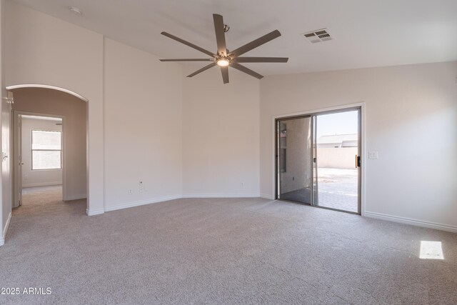 41767 W Somerset Dr, Maricopa, AZ 85138 - empty room featuring ceiling fan, arched walkways, light carpet, and high vaulted ceiling