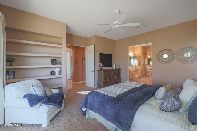 bedroom with carpet, visible vents, ceiling fan, and ensuite bathroom