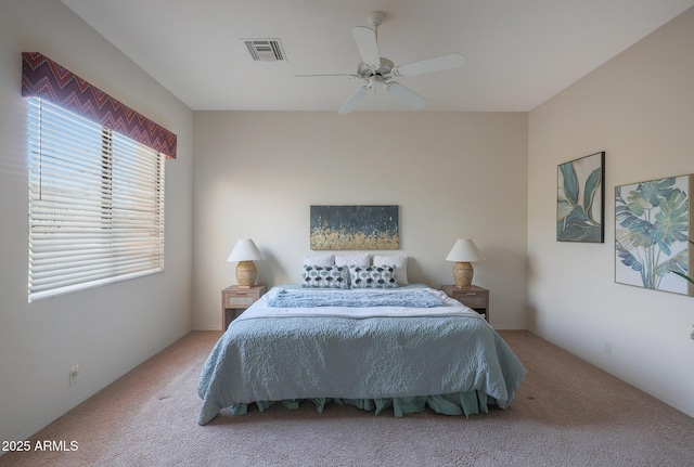 bedroom with ceiling fan, visible vents, and carpet flooring