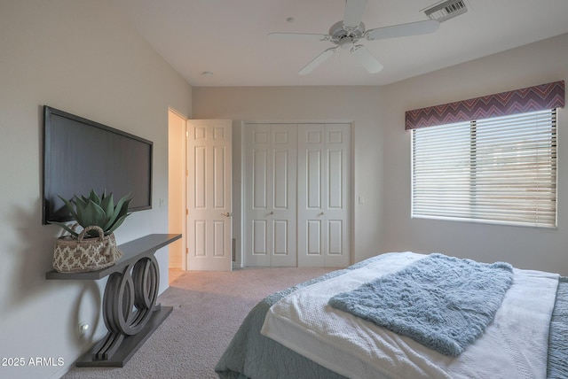 bedroom featuring carpet, visible vents, ceiling fan, and a closet