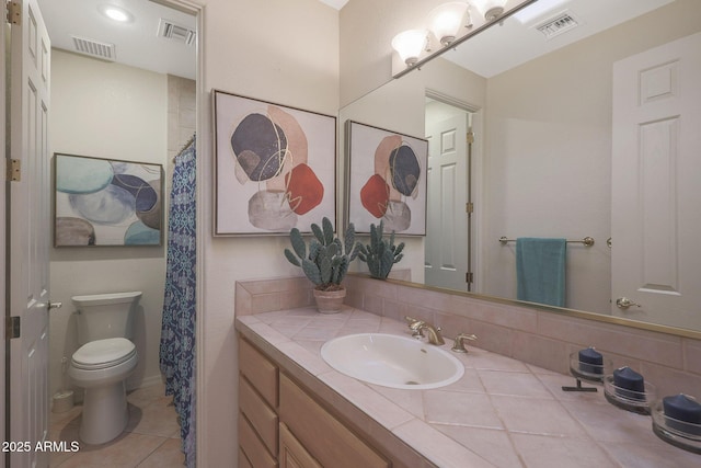 bathroom with toilet, visible vents, and vanity