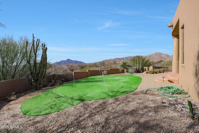 view of yard featuring a fenced backyard and a mountain view