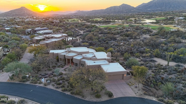 aerial view at dusk featuring a mountain view