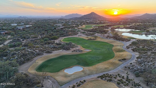 bird's eye view featuring view of golf course and a water and mountain view