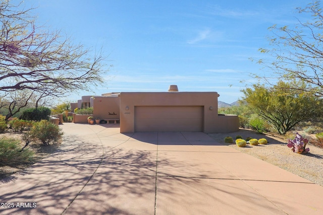 view of side of property featuring a garage, driveway, and stucco siding