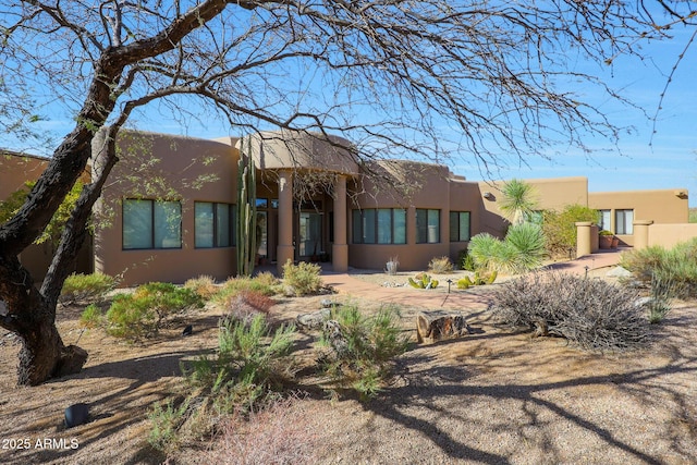 pueblo-style home with stucco siding