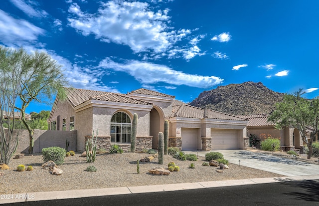 mediterranean / spanish-style house featuring a mountain view and a garage