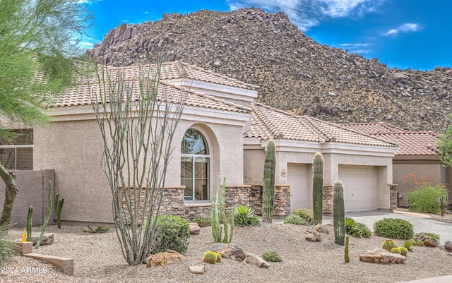 view of front facade featuring a mountain view and a garage