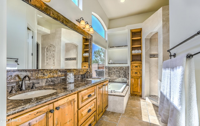 bathroom with vanity, vaulted ceiling, and separate shower and tub