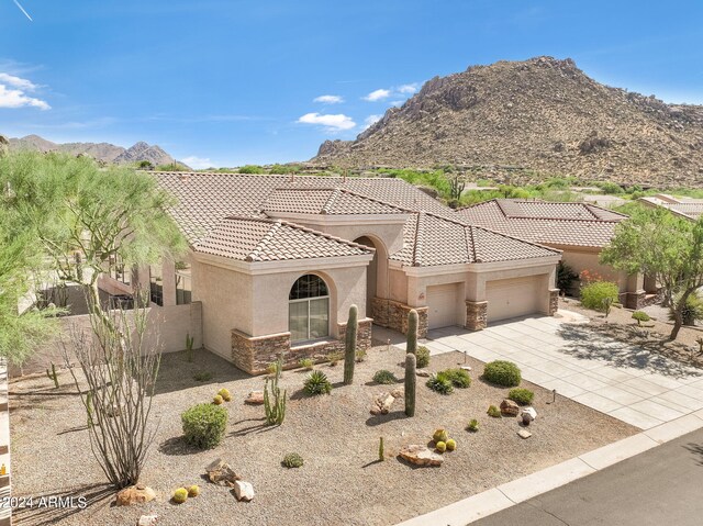 view of front of home with a garage and a mountain view