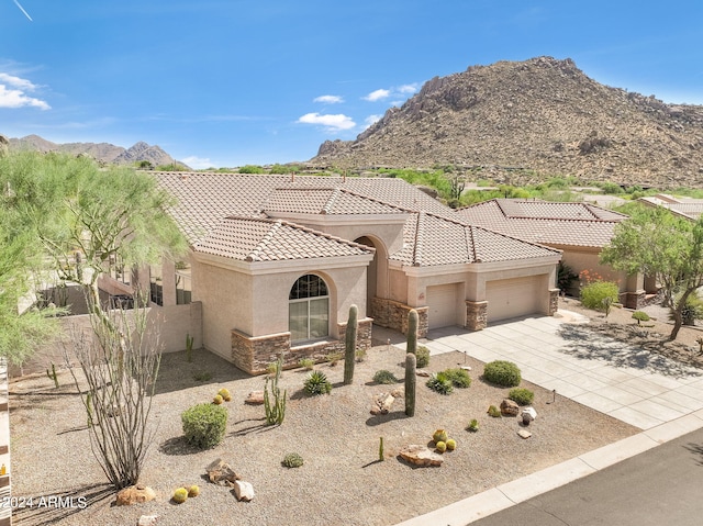 view of front of home featuring a mountain view and a garage