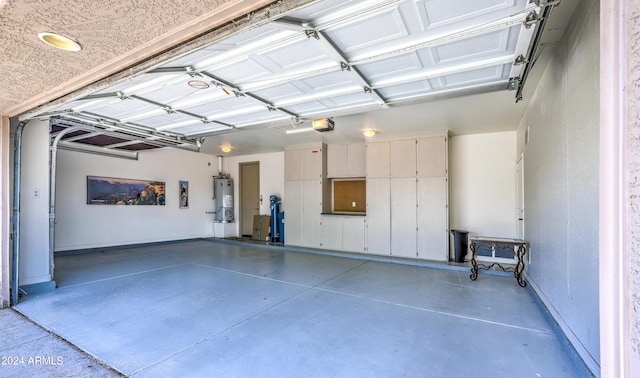 garage featuring a garage door opener and water heater