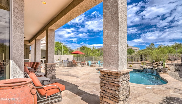 view of patio / terrace with a fenced in pool and pool water feature