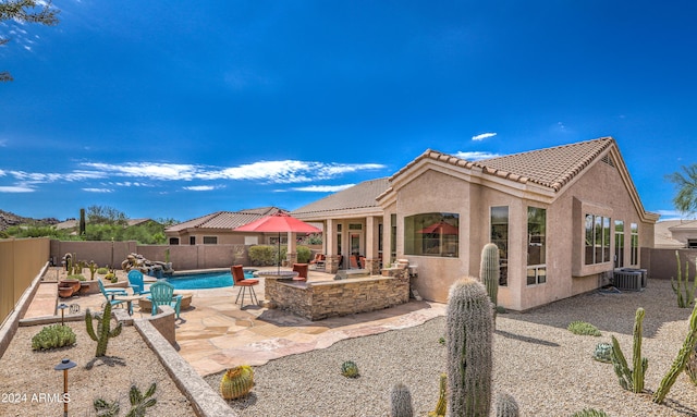 exterior space with a fenced in pool, a patio area, and central air condition unit