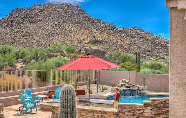 view of swimming pool featuring an outdoor fire pit and a patio