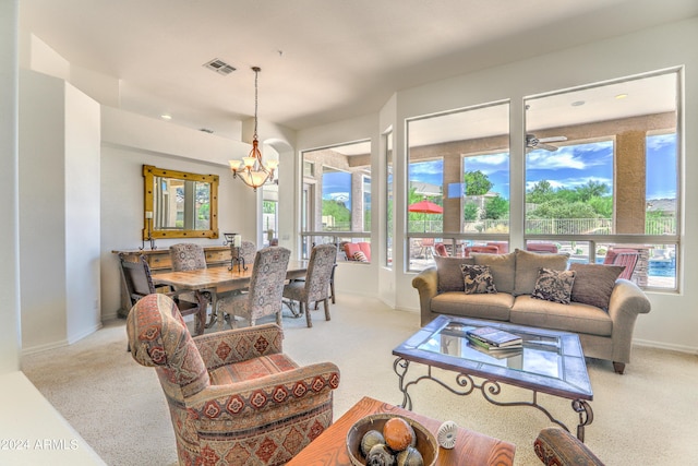 living room featuring a wealth of natural light and a notable chandelier