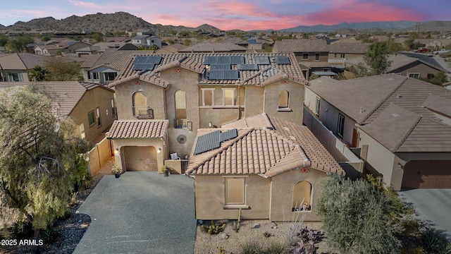 view of front facade with a garage and solar panels