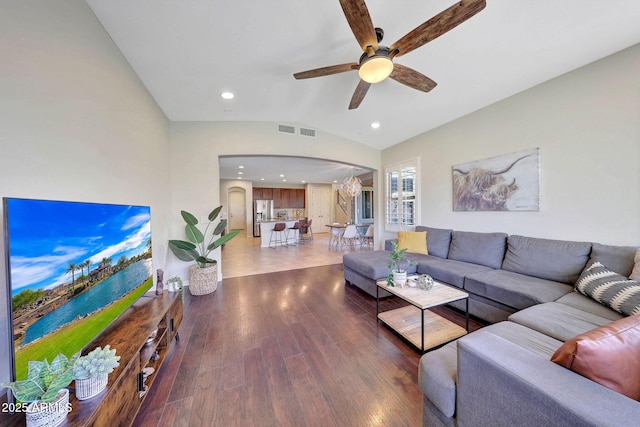 living room with vaulted ceiling, dark wood-type flooring, and ceiling fan