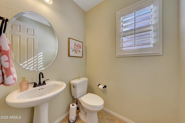 bathroom featuring sink, tile patterned floors, and toilet