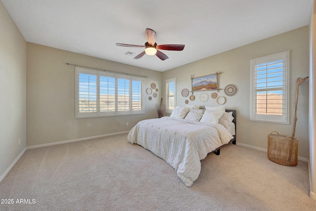 bedroom featuring ceiling fan and light carpet