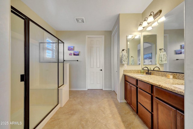 bathroom with vanity and an enclosed shower