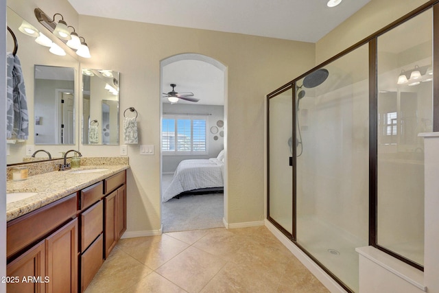 bathroom featuring ceiling fan, vanity, an enclosed shower, and tile patterned flooring