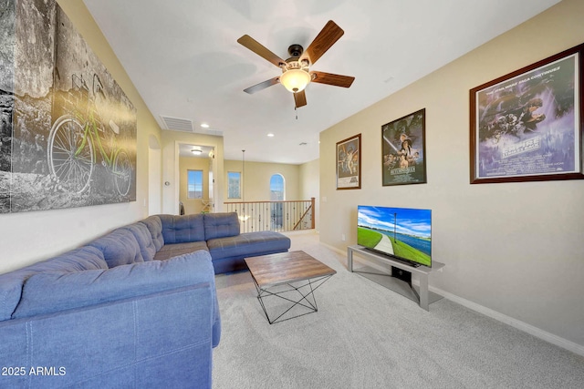 carpeted living room with ceiling fan