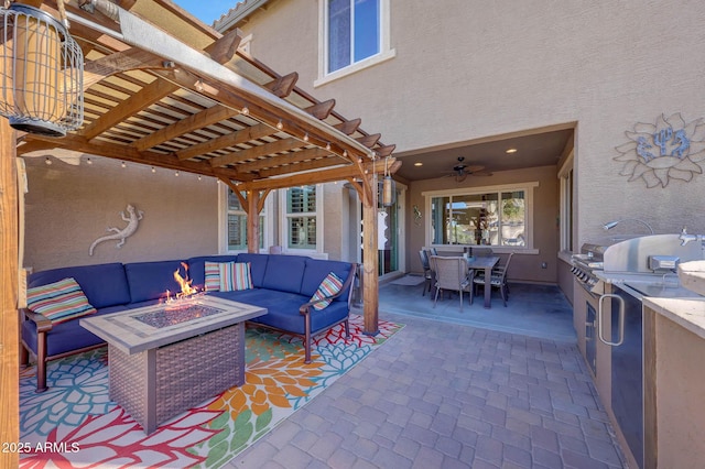 view of patio / terrace with area for grilling and an outdoor living space with a fire pit