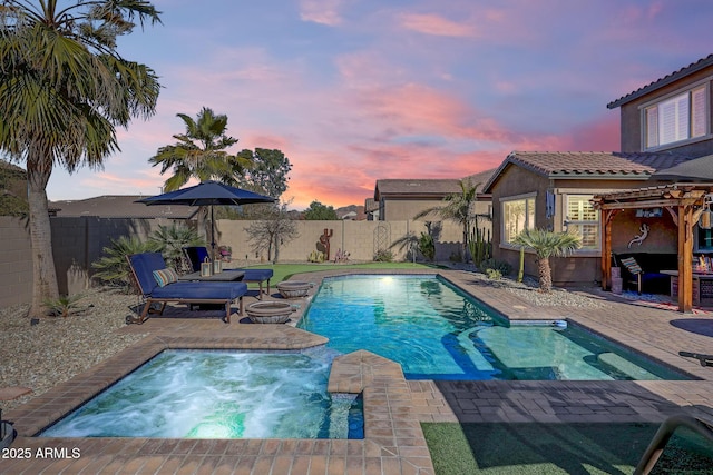 pool at dusk featuring a patio area