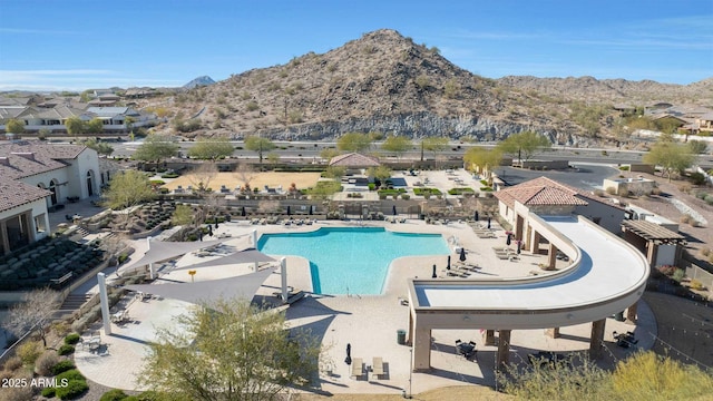 view of swimming pool with a patio and a mountain view