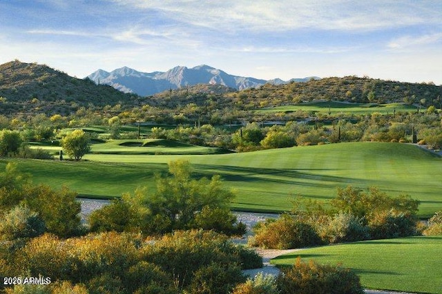 view of property's community with a yard and a water and mountain view