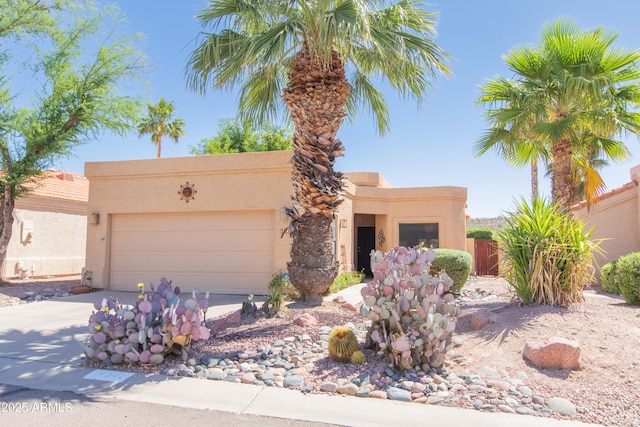 17342 E Quail Ridge Dr, Fountain Hills, AZ 85268 - pueblo-style home with stucco siding, a garage, driveway, and fence