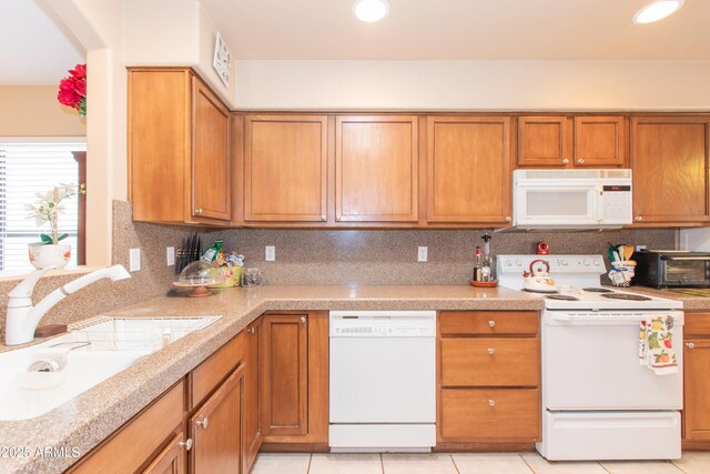 17342 E Quail Ridge Dr, Fountain Hills, AZ 85268 - kitchen with white appliances, a sink, brown cabinetry, light countertops, and light tile patterned floors