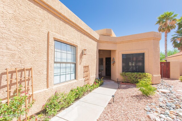 17342 E Quail Ridge Dr, Fountain Hills, AZ 85268 - doorway to property with stucco siding and fence