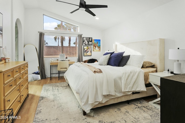 bedroom with light hardwood / wood-style flooring, ceiling fan, and lofted ceiling